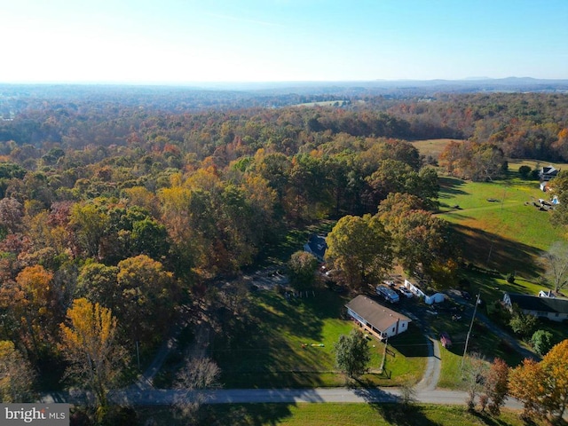 drone / aerial view with a wooded view