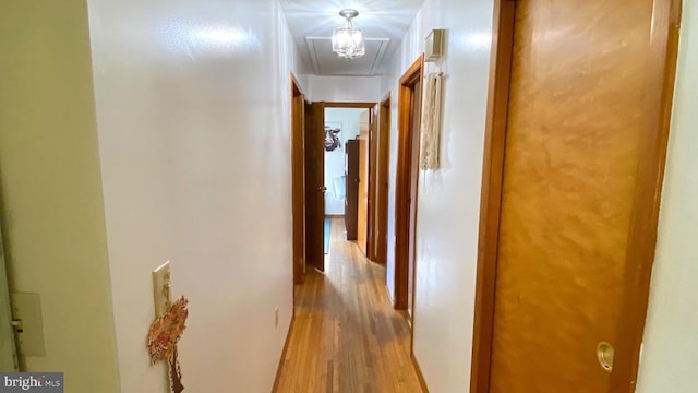 hallway with light hardwood / wood-style flooring