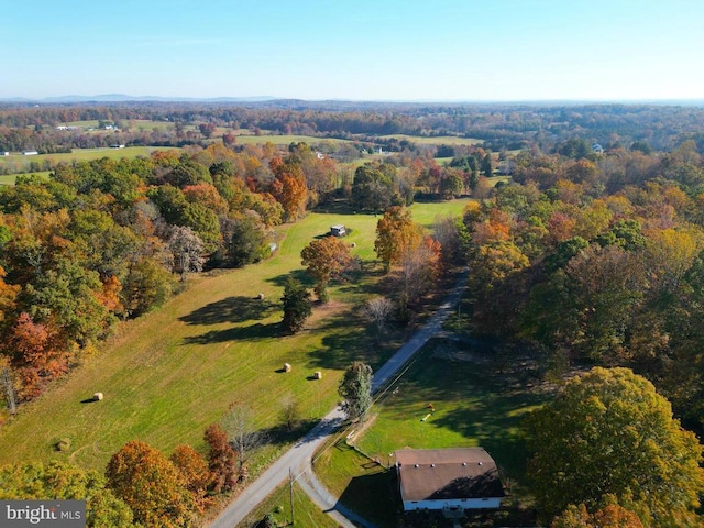 drone / aerial view featuring a view of trees