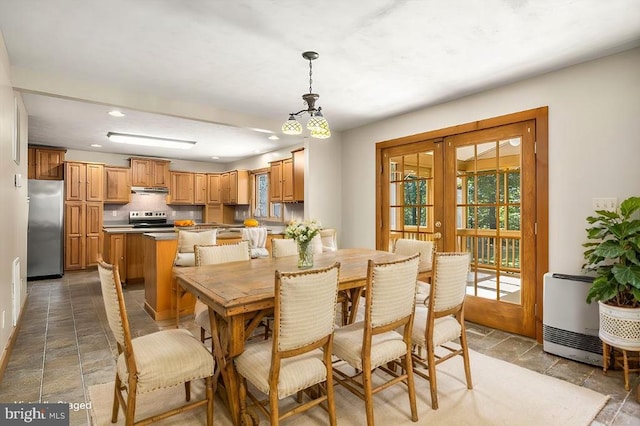 dining space with heating unit and french doors