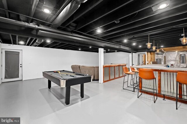 playroom featuring billiards, concrete flooring, and indoor bar