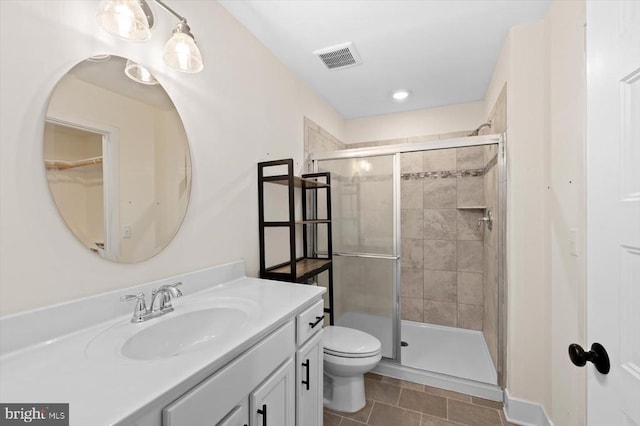 bathroom featuring vanity, an enclosed shower, tile patterned floors, and toilet