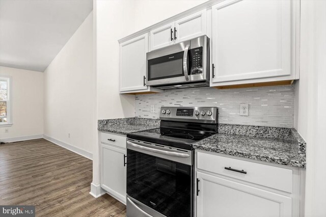 kitchen with stainless steel appliances, white cabinets, backsplash, and stone counters