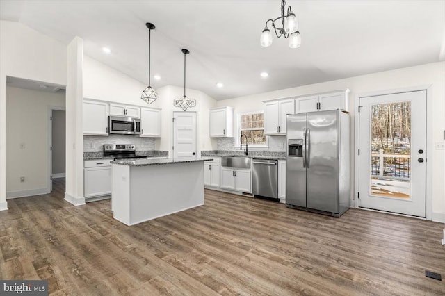 kitchen featuring pendant lighting, white cabinetry, and appliances with stainless steel finishes