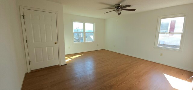 spare room with hardwood / wood-style flooring and ceiling fan