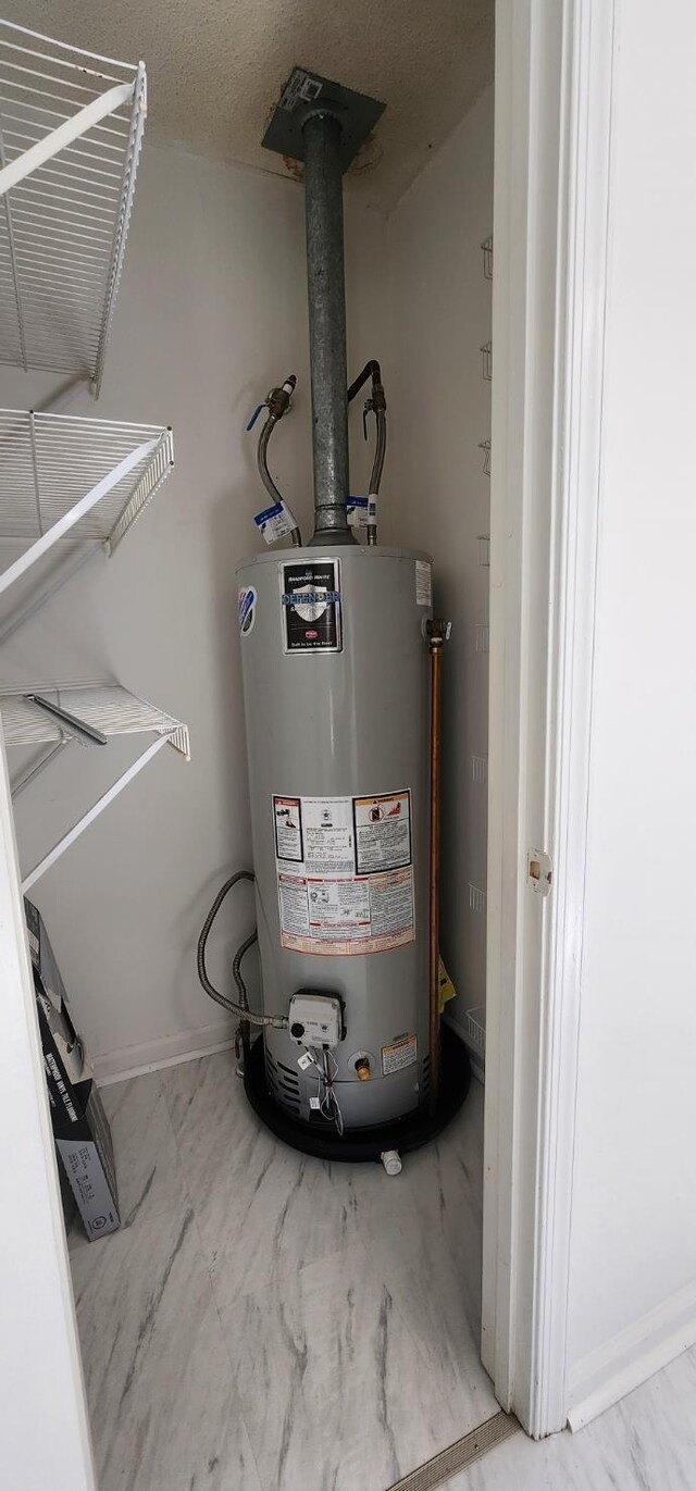 utility room featuring gas water heater