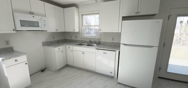 kitchen with white cabinetry, sink, and white appliances