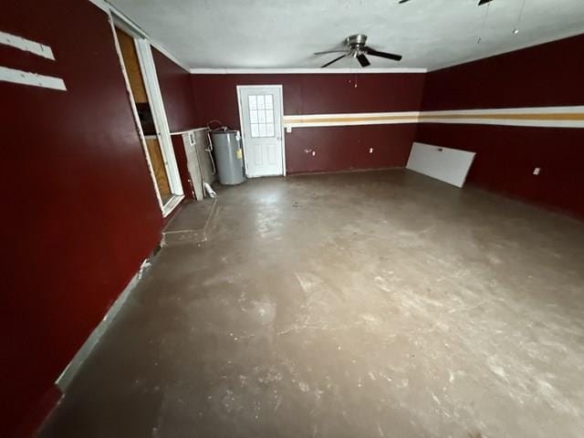 interior space featuring ceiling fan, water heater, and concrete flooring