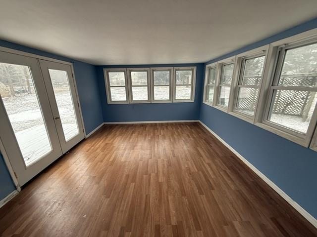 unfurnished sunroom featuring french doors