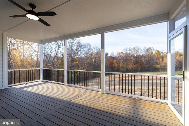 unfurnished sunroom with ceiling fan and a healthy amount of sunlight