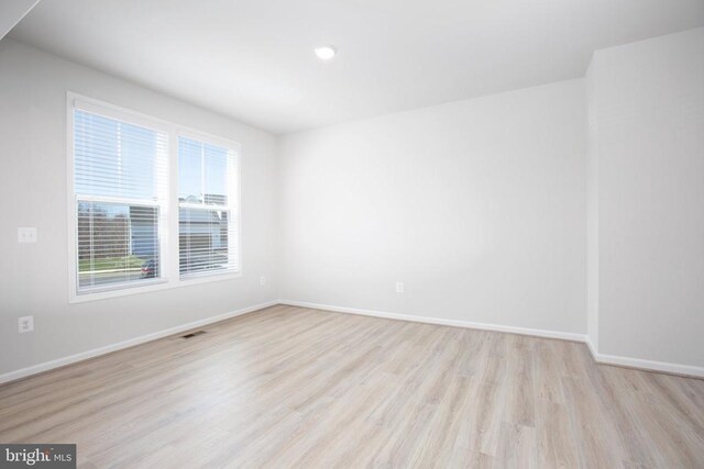 empty room with light hardwood / wood-style floors