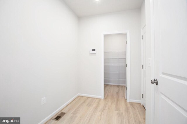 hall with light hardwood / wood-style floors