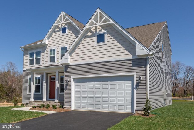 view of front of property with a garage and a front lawn