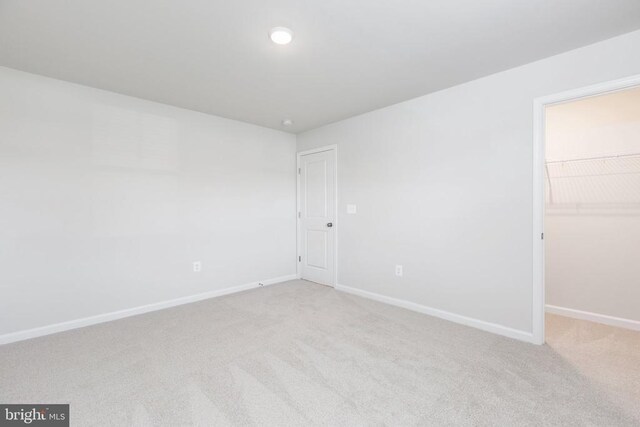 spare room with light colored carpet