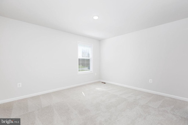 empty room featuring light colored carpet