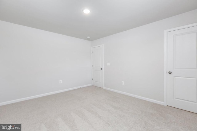 unfurnished room with light colored carpet