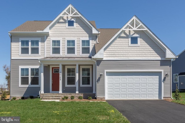 view of front of property with a garage and a front yard