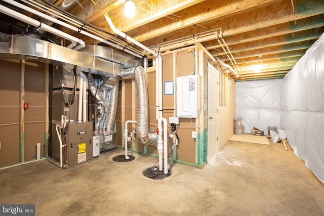 basement featuring heating unit and electric panel