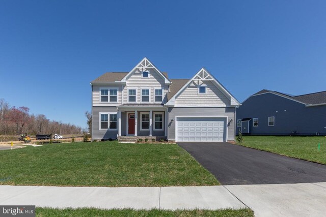 view of front of house featuring a garage and a front yard