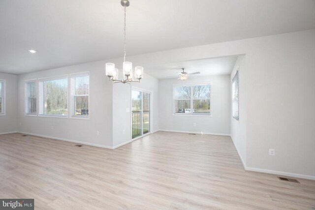 interior space with light hardwood / wood-style floors and a notable chandelier