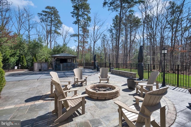 view of patio featuring a fire pit, a gazebo, and fence