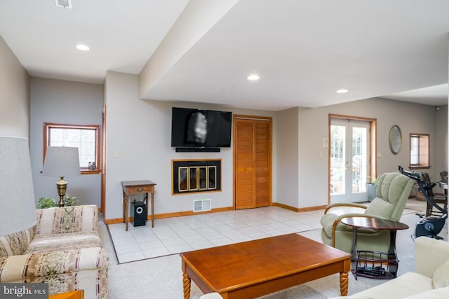 living room featuring light tile patterned flooring, recessed lighting, visible vents, baseboards, and french doors