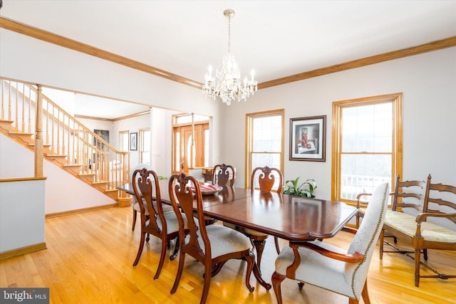 dining area featuring crown molding, stairway, an inviting chandelier, light wood-type flooring, and baseboards