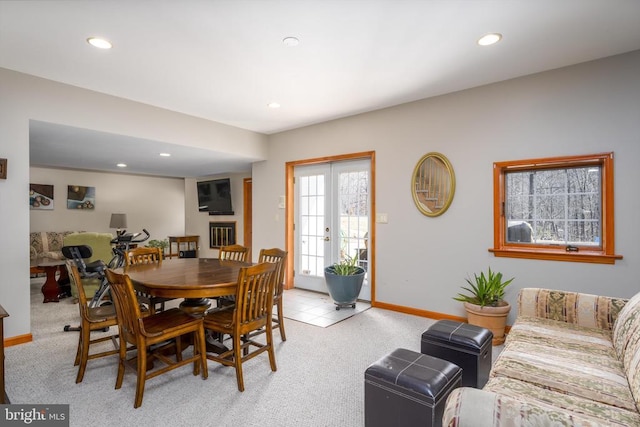 dining space featuring recessed lighting, french doors, and light colored carpet