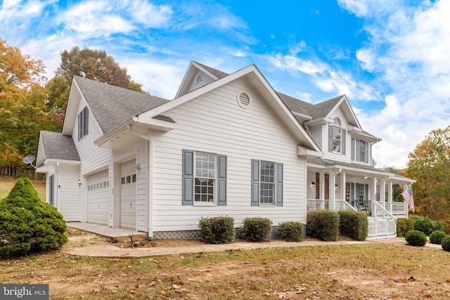 view of property exterior featuring an attached garage, a shingled roof, and a porch