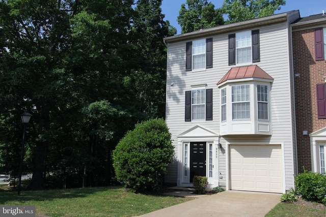 townhome / multi-family property with a garage and driveway