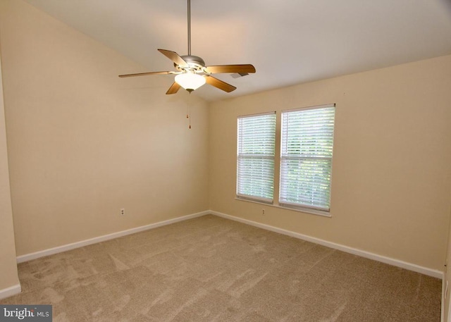 unfurnished room featuring light carpet, baseboards, and a ceiling fan