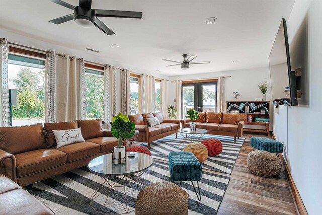 living room with ceiling fan and light hardwood / wood-style flooring