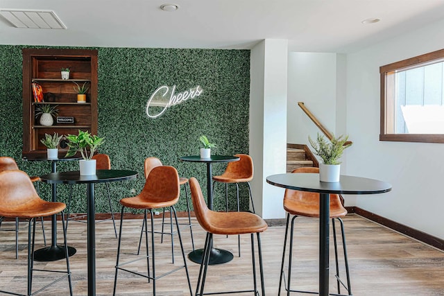 bar with light hardwood / wood-style floors