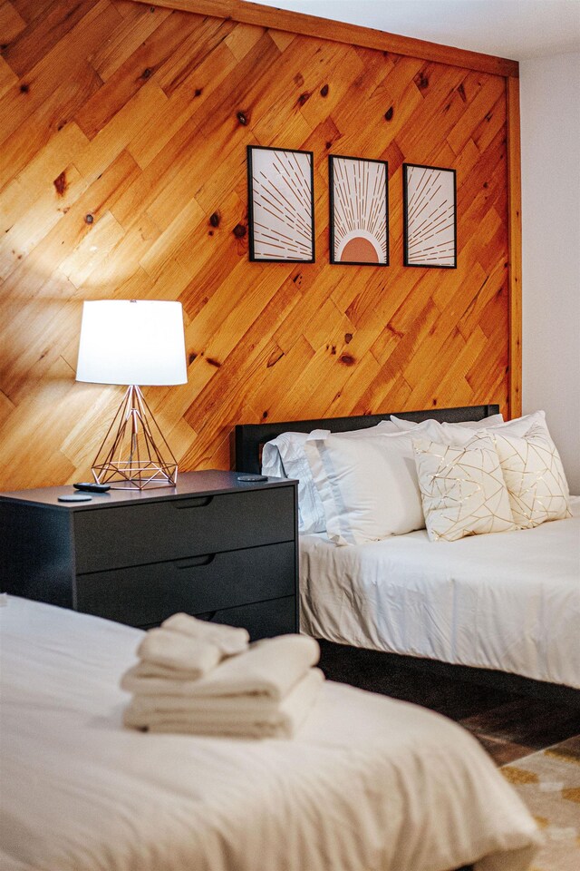 bedroom with wooden walls