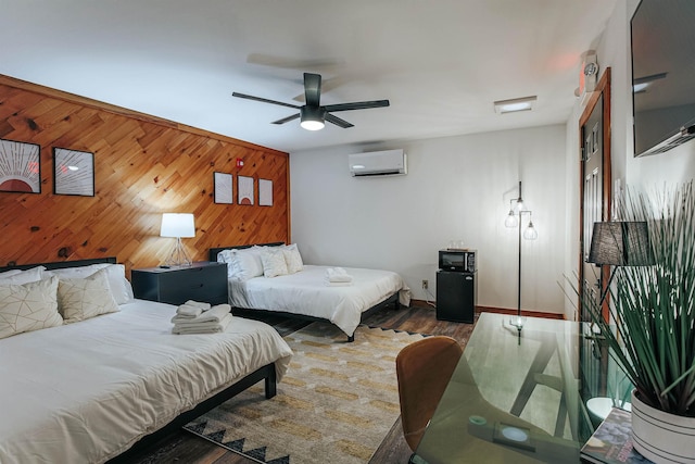 bedroom featuring dark hardwood / wood-style floors, ceiling fan, wooden walls, and a wall mounted AC