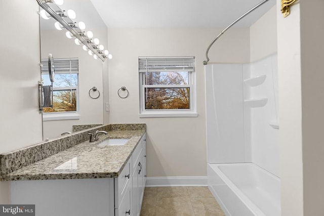 full bathroom featuring vanity, tile patterned floors, baseboards, and shower / bathtub combination