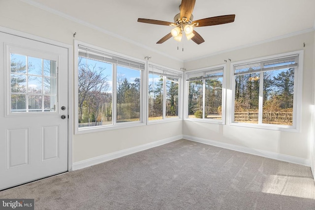 unfurnished sunroom featuring ceiling fan