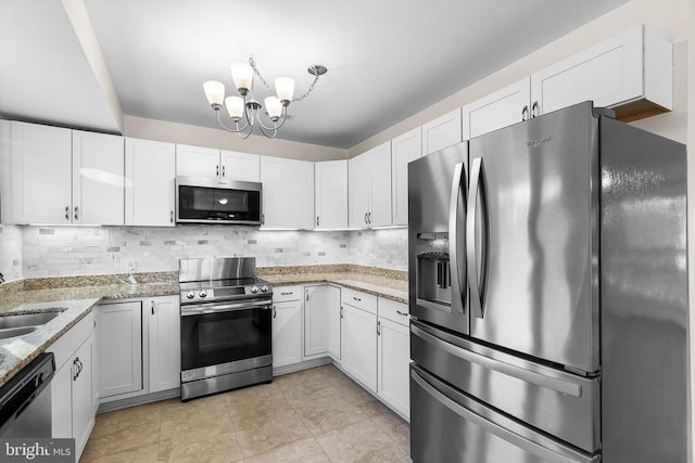 kitchen featuring stainless steel appliances, backsplash, and white cabinetry