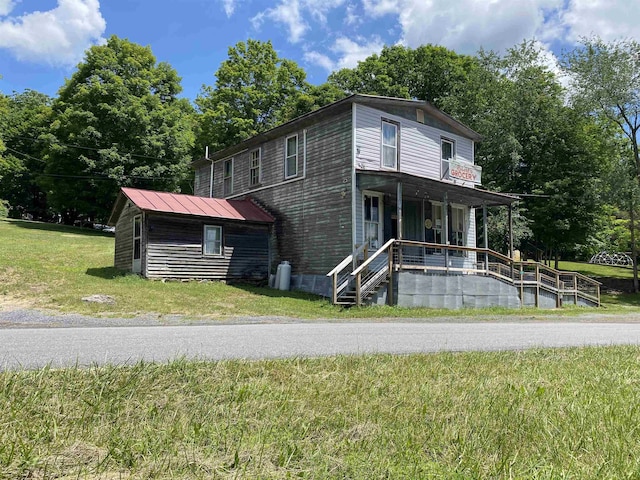 view of front of property with a porch and a front lawn