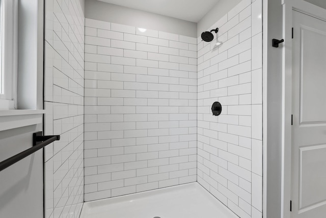 bathroom with a tile shower