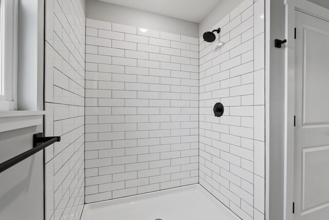 bathroom with a tile shower