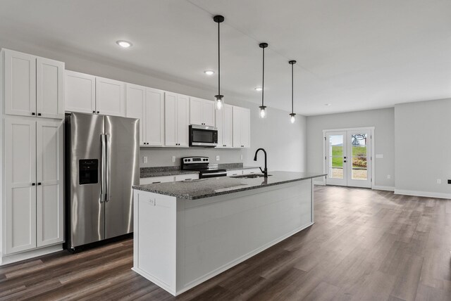 kitchen featuring sink, an island with sink, white cabinets, and appliances with stainless steel finishes