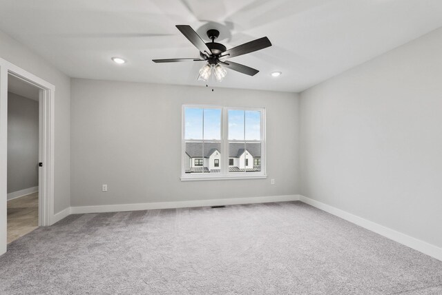 unfurnished room with carpet floors and ceiling fan