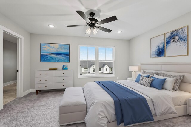 bedroom featuring light carpet and ceiling fan