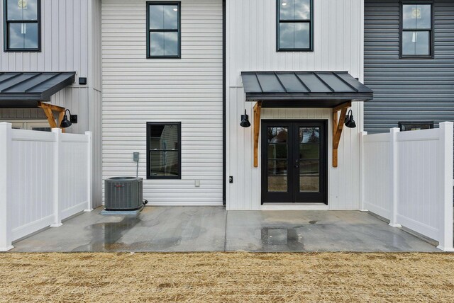 doorway to property featuring cooling unit, a patio area, and french doors