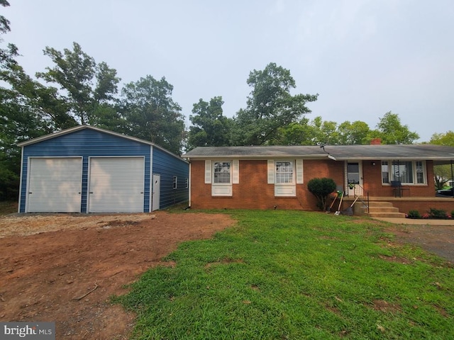 view of front of home with an outbuilding, a garage, and a front yard