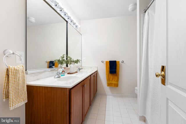 bathroom featuring vanity, tile patterned flooring, and toilet