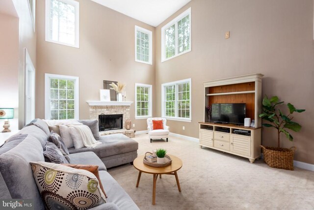 living room with carpet floors and a towering ceiling