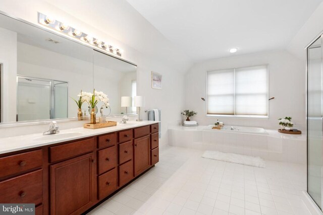 bathroom with vaulted ceiling, shower with separate bathtub, and vanity