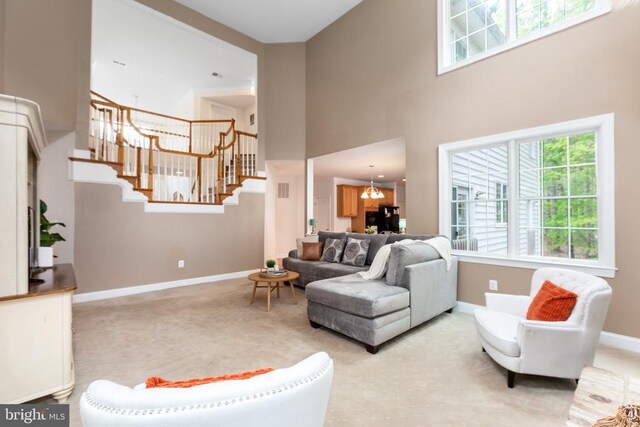 living room with an inviting chandelier and a high ceiling